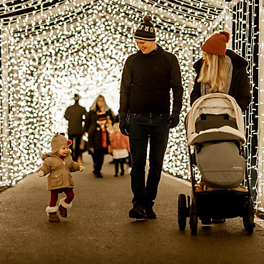 Young family walking through tunnel of light